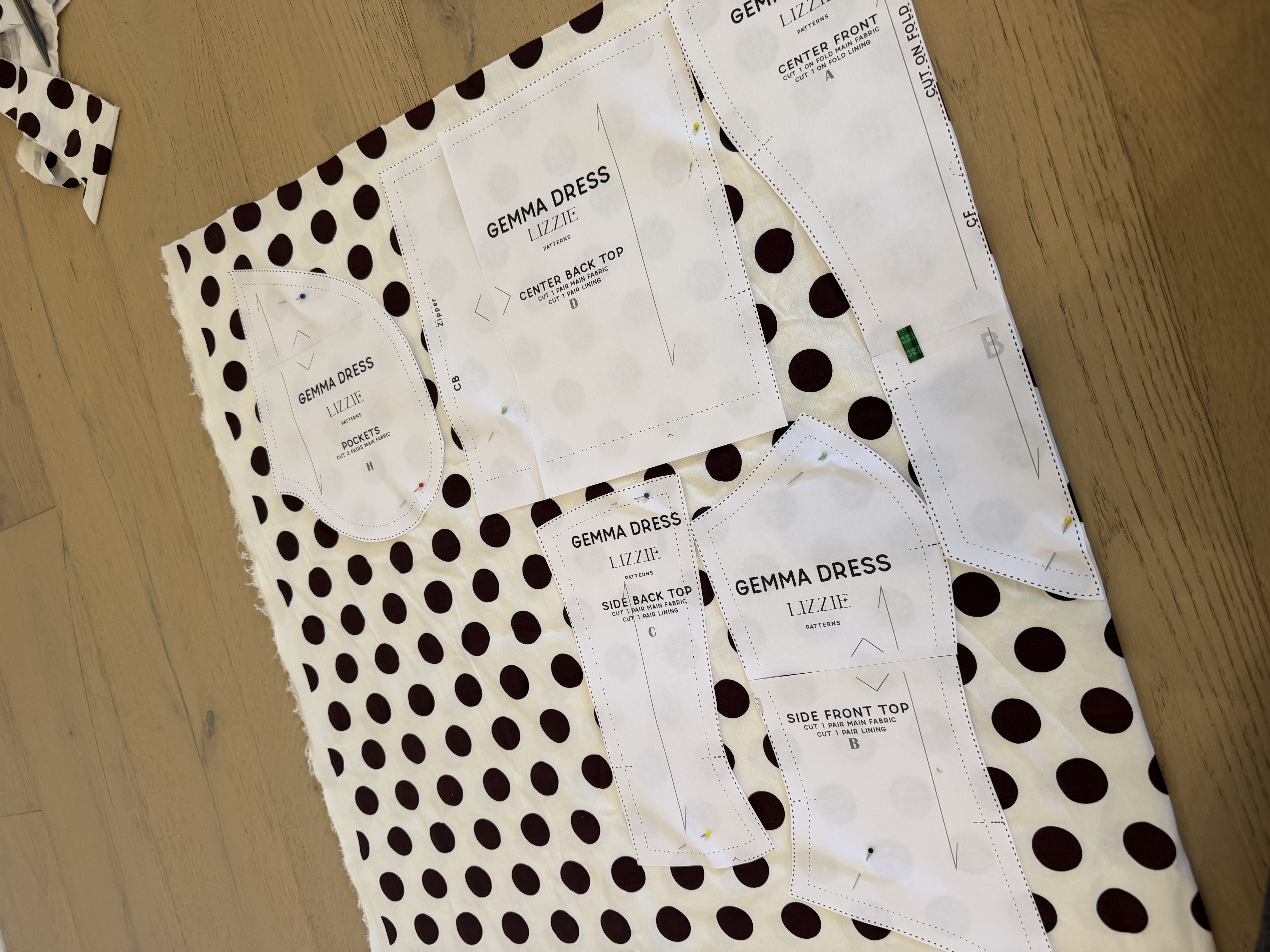 Gemma Corset Dress pattern pieces cut out of the polka dot cotton